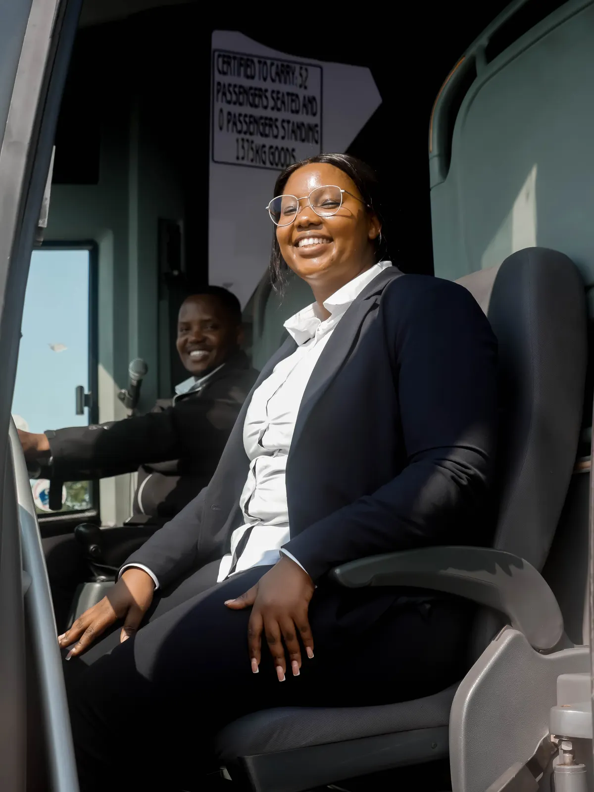 A smiling Chumile driver at the wheel of a coach
