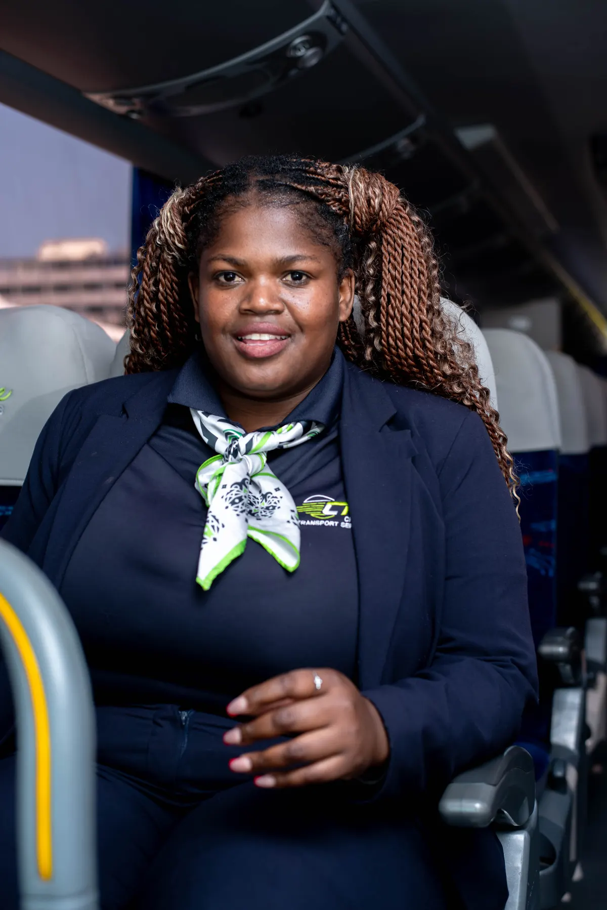A Chumile hostess seated in a coach